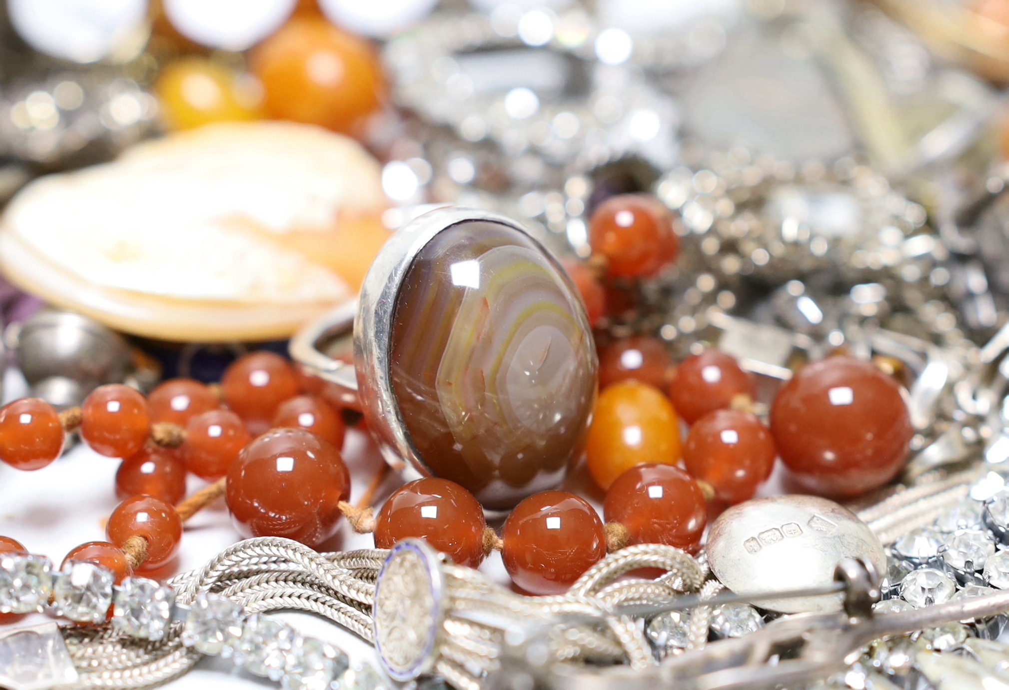 Mixed costume jewellery including a silver, marcasite and moonstone set flower brooch, faux amber beads, etc. and a silver five bar toast rack.